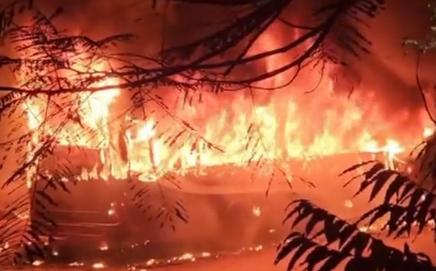 Flames rise after a fire broke out in a bus, at Vikaspuri, in New Delhi. Pic/PTI